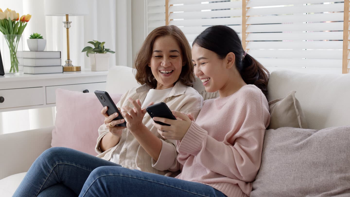 Attractive beautiful asian family sit sofa couch living room enjoy urban life joyful promotion